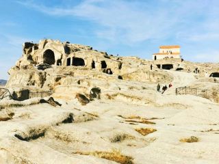 Uplistsikhe –visit the ancient cave town
If you’re staying in Tbilisi and looking for an easy half-day trip, Uplistsikhe is one of the best places to visit. It’s an ancient cave city carved directly into rock – older than most people expect – and walking there really feels like stepping into a different era. Smooth stone paths, old wine presses, hidden tunnels, and views over the Mtkvari River make it a perfect mix of history and scenery.

How to get there from Tbilisi? 
The easiest option is a taxi or a private transfer.
•  Travel time: around 1 hour
•  Price: usually 80–120 GEL round trip depending on your negotiation skills
Tip: ask the driver to wait ~1.5-2 hours – that’s enough to explore the whole site.
There’s also a marshrutka from Didube to Gori, and from Gori you need a taxi to Uplistsikhe. This combo is cheaper, but definitely slower and less convenient. If you travel as a couple or group, taxi is better.

How to get there from Kutaisi? 
Travel time is around 2.5 hours by taxi. If you combine it with Mtskheta or Gori, it becomes a great full-day trip.

What to expect? 
Uplistsikhe is a surprisingly large complex, spread across a rocky hill. You’ll see:
•  ancient cave dwellings
•  the main hall carved into the cliff
•  old pagan temples
•  a stone-cut theatre
•  tunnels used for escaping during invasions
•  a beautiful church standing above all caves
Views from the top are fantastic, especially before sunset.

Practical tips
•  Entry fee: 15 GEL
•  Wear shoes with good grip – rocks can be slippery
•  There’s almost no shade, so bring water and a hat
•  Visiting time: 1-2 hours is enough for most people
•  You can combine Uplistsikhe with Gori Fortress or the Stalin Museum in one trip

Is it worth it?
Definitely#travel . It’s one of the easiest day trips from Tbilisi and gives you a quick, interesting look into Georgia’s ancient history without long hiking or complicated logistics. And the landscapes alone make it worth the visit.
#georgia #uplistsikhe #cave #staycation #daytrip #tbilisi #traveltips 