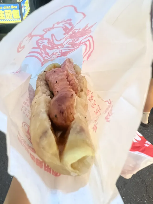 夜市的大腸包小腸，糯米腸夾香腸以紙袋盛裝