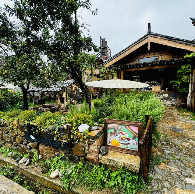 Quaint stone village under Yulong Mountains
