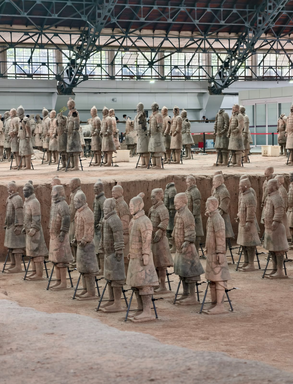 The Eighth Wonder of the World: How to Visit the Terracotta Army in Xi'an Without Disappointment

The Terracotta Army isn't just one of China's top tourist attractions; it's a place that completely reshapes your understanding of history. Thousands of life-sized clay warriors, standing guard underground for over 2,000 years, make for a truly breathtaking sight. To make sure your trip leaves you with unforgettable memories instead of frustration from crowds and exhaustion, we've rounded up the ultimate travel hacks from those who have been there and done that.

🏛️ Why is it worth seeing?

Back in 1974, local farmers digging a well had no clue they were about to stumble upon one of the greatest archaeological discoveries of the 20th century. This subterranean army guards the tomb of Qin Shi Huang, the first emperor of a unified China. The biggest mind-blower for travelers? Every single one of the 8,000+ warriors has a completely unique face. There are no "cookie-cutter" soldiers here: different hairstyles, armor, and even facial expressions. Ancient master artisans crafted them all by hand, and rumor has it, they were modeled after real-life soldiers. The complex has been proudly rocking its UNESCO World Heritage status since 1987.

🗺️ The ultimate viewing secret (so you don't ruin the vibe)

The main complex consists of three pavilions (pits) showcasing the excavations. Rookies often make a classic mistake: making a beeline straight for Pit No. 1, the largest and most iconic hall packed with endless rows of warriors. After such an epic spectacle, the other pits just feel a bit underwhelming in comparison.

Work your way up, saving the best for last:

1. Start with Pit No. 3 — this is the smaller "command post."
2. Next, head over to Pit No. 2 — here you can check out the finer details and different military ranks.
3. Only at the very end should you step into Pit No. 1 for a grand finale of mind-boggling scale. That "wow" factor is totally guaranteed!

🚀 How to get there from Xi'an

The complex is located about 40 km from the city center.

· 🚇 The budget-friendly option (around 10 RMB): Take Metro Line 9 to Qinling West (or Huaqing Pool) station, then hop on a special shuttle bus for 2 RMB that drops you right at the entrance.
· 🚕 Taxi (about 80–100 RMB): It's super easy to call a Didi. The ride takes just over an hour. Drivers know the spot, but it's always smart to have the Chinese name handy to show them.
· 🚌 Tourist bus: You can score a direct transfer ticket bundled with your admission (around $3.50).

⏰ When to go & other must-know tips

· Book your tickets in advance! Daily caps sell out lightning fast, especially on weekends and public holidays. You can grab them on Trip.com, but absolutely do not forget your original physical passport — they won't let you in with just an e-ticket.
· Be an early bird. By 10–11 AM, the pavilions turn into an absolute madhouse. The golden hour is right when the doors open.
· Don't sleep on the Bronze Chariot Museum. It's located over in Lishan Park (you won't find them in the main pits!), and there's a free shuttle bus to get you there. A lot of tourists skip it, but that's a huge rookie mistake — the Emperor's bronze chariots are just as epic as the warriors.
· Shoes and zoom lenses. Lace up some comfy sneakers — you're going to be getting your steps in. And to catch the unique facial features of the warriors deep down in the trenches, definitely bring a phone or camera with a killer zoom.

If you have some time to kill, there are cafes and food courts on-site where you can chill out and sip some tea. The Terracotta Army totally lives up to the hype, as long as you plan your visit like a pro.