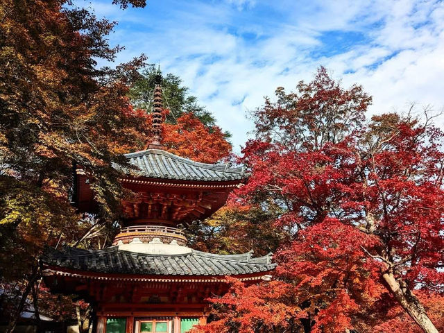 An ancient temple with a beautiful vermilion-painted Taho Pagoda and the a