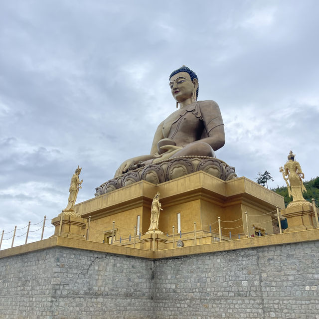 Golden shining Buddha atop a hill 