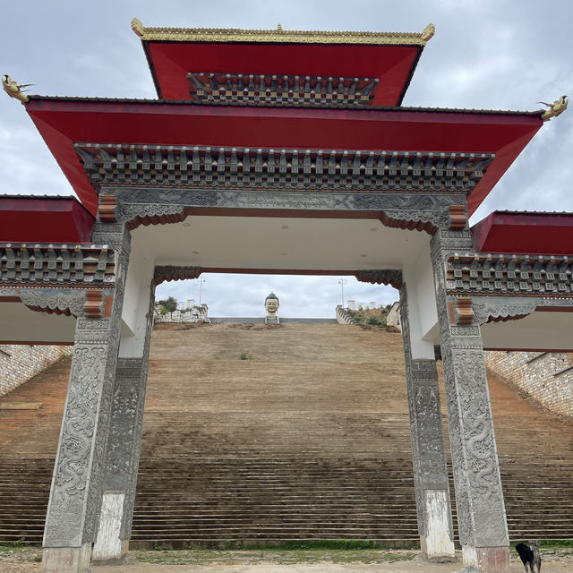 Golden shining Buddha atop a hill 