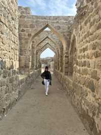 “Whispers of the Past: The Timeless Walls of Bahrain Fort”