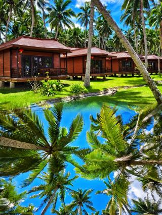 Where can the evening stretch coconut shadows so long that every step lands in tenderness?