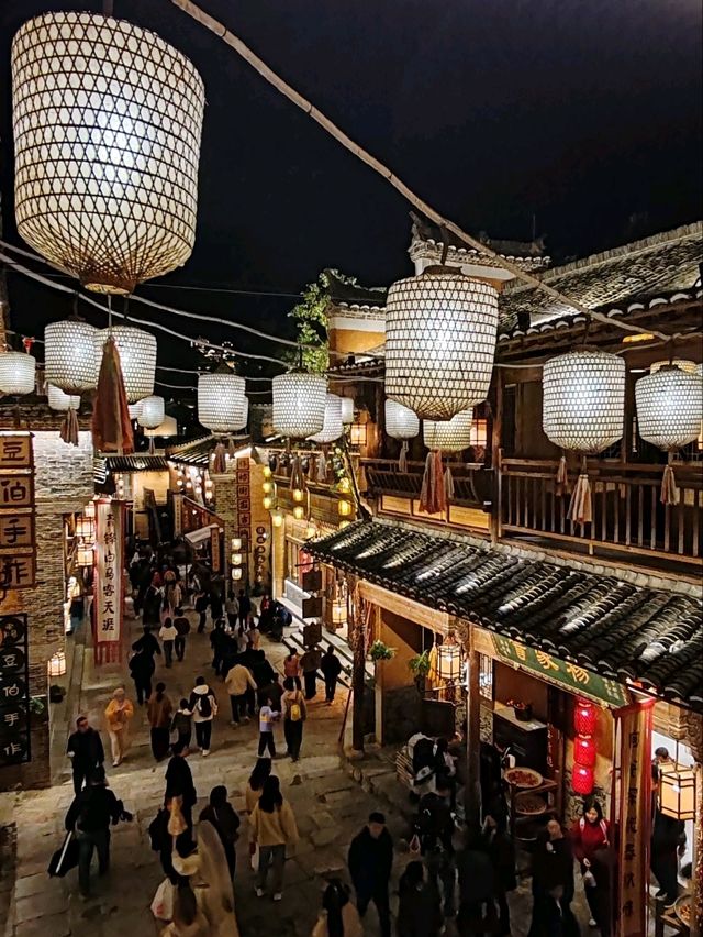 Wangxian Valley: Night Market Lights Reflecting Visitors
