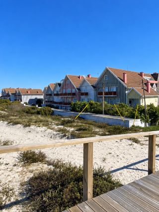 🇵🇹 Praia da Costa Nova | Portugal 🌊☀️

Another beach in Portugal with an amazing atmosphere 💙

Praia da Costa Nova is a charmingly simple beach near Aveiro. It's not flashy, but the views are incredibly relaxing.

I love the wooden walkway that winds through the white sand dunes, lined with natural grass. Walking along, you'll eventually reach the vast Atlantic Ocean. On a clear day, the blue sky contrasting with the white sand is stunning; the photos turn out beautifully without needing any editing 📸

This place feels peaceful and relaxing, perfect for a leisurely stroll along the beach, letting your mind wander. Just walking on the wooden bridge and enjoying the views is incredibly enjoyable.

Another interesting feature is the colorful striped houses that are a unique characteristic of the Costa Nova area. If you're visiting Aveiro, I recommend allocating time to explore both the beach and the village.

It's another charming and simple side of Portugal. But it's truly charming 🤍

📍 Praia da Costa Nova, Aveiro, Portugal 🇵🇹

#PraiaDaCostaNova #CostaNova #Aveiro #Portugal #TravelPortugal #PortugalTravel #IndependentTravel #InternationalTravelReview