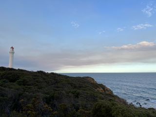 The Tranquil Silhouette of the Coast's Guardian: Little Red Riding Hood Lighthouse