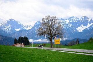 Discover the hidden gem of Füssen, a romantic town nestled in the embrace of the Alps amidst lush green meadows.