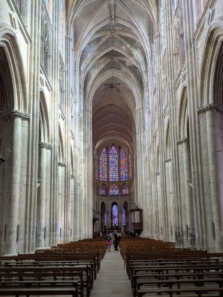 Located in the heart of historic Tours, Cathédrale Saint-Gatien is one of the Loire Valley's most remarkable Gothic landmarks. What makes a visit here so special is how seamlessly it blends centuries of history—from its 13th-century High Gothic choir to its ornate Flamboyant facade and Renaissance towers. Inside, the star attraction is the cathedral's light-filled interior. Alongside brilliant 13th- to 16th-century stained glass windows, Saint-Gatien stands out for featuring magnificent modern stained glass installations created by 20th-century master glassmakers.

Practical Logistics
Location: Place de la Cathédrale, 37000 Tours, France.
Transit: Just a short, flat 10-minute walk northeast of the main train station (Gare de Tours).
Walking Tour Route: Perfect for a low-effort city walking tour! Combine your cathedral visit with the adjacent Cloître de la Psalette, the nearby Musée des Beaux-Arts garden, and a stroll down to the Loire riverbanks.

Costs & Tickets
Entry Fee: Completely free public entry to the cathedral nave, side chapels, and transepts.
Visitor Info: Plenty of free informational leaflets, printed guides, and explanatory signs are provided near the entry points and throughout the nave, making self-guided exploring effortless.

Insider Tips
Best Time to Visit: Head inside during the afternoon when sunlight streams directly through the windows and side bays, casting colorful glass reflections across the stone floor.

Spotting Details: Keep an eye out for the self-service leaflet racks at the entrance for detailed maps pointing out key historical features, like the 16th-century grand organ buffet in the south transept.

Interior & Ambience Detail
The interior is vast, peaceful, and awe-inspiring, defined by towering vaulted ceilings and long rows of wooden pews leading toward the illuminated choir. Slender stone columns draw your eyes upward to the clerestory windows, where ancient figurative glass panels sit in striking harmony with the bold, gem-toned geometric patterns of the modern mid-century glasswork.