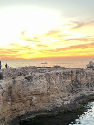 Batroun is THE spot if you’re chasing epic Mediterranean sunsets and charming village vibes 🌅🧡 The Lebanese Diaspora Village here seriously delivers on both, making it a must-stop for anyone visiting Lebanon’s northern coast.

Must-See Place in Batroun:
Lebanese Diaspora Village – Batroun  
Address: 7M44+5WG 1400, Batroun, Lebanon  
Opening hours: Usually open till sunset (go late afternoon for the magic hour!)

Why hit this spot? It’s not just a pretty place—the village is packed with cool stories about Lebanese emigrants and local culture. Stroll the stone lanes, dip into cute artisan shops, then post up for the best sunset view you’ll get in Lebanon. That golden hour glow here is next level—trust me, you don’t want to miss it!

Local Tip: Aim to arrive about an hour before sunset so you can explore the village and claim a spot with the clearest view out over the Mediterranean. Bring a camera and something comfy to sit on.

Getting around Batroun:  
Walk everywhere! The town is safe and best experienced on foot. If you’re coming from Beirut, grab a bus or shared taxi heading north—the ride’s an easy 1-2 hours along the coast.

Food Alert:  
Don’t skip Batroun’s legendary lemonades (try Hilmi’s on the main drag) and hit up a waterfront seafood spot after sunset—ask locals for their current favorite!

Destination tips:  
No visa needed for most travelers (check if you’re unsure), cash is king, and summer months (May–September) mean perfect sunset weather.

#BatrounSunsets #LebanonTravel #DiasporaVillage #MediterraneanVibes