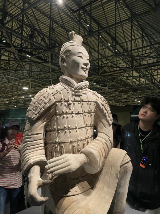 Hello, friend! If you're in Xi'an, the one place you absolutely cannot miss is the "Terracotta Army." 🏺

1. How to Get There?
We took a taxi from the heart of Xi'an, which cost about 40 RMB and took around 50 minutes. You could take the metro to Huaqingchi Station (Exit C) and then catch the Lintong 613 or Lintong 602 bus, but that’s much more exhausting and time-consuming. To make navigating the subway easier, download the "Xi’an Subway" app. 🚇

2. Getting Your Tickets
You’ll be dropped off at a large square with a semi-circular monument. There are tourist information centers on both the left and right sides where you can buy tickets for 120 RMB using your passport. The ticket covers both the Terracotta Army and the Lishan Garden (the Emperor’s burial site). 🎫

3. The Entrance
Head to the central entrance with turnstiles for security and document checks (passport, tickets, and bags).

4. The Park
After the turnstiles, there’s a small park. It's about a 5-minute walk—just head straight along any of the paths; they all lead to the second ticket checkpoint.

5. Finding Your Way
Along the way, you’ll see maps showing the different locations: the pits, excavation sites, and the museum. Instead of hiring a guide, we used ChatGPT, which was both interesting and convenient! 🤖

6. Pit 1
Immediately after the second checkpoint is Pit 1. This is the largest excavation site, featuring thousands of infantry warriors.

7. Pits 2 and 3
These pits contain the command post and the cavalry. Don’t rush through the outdoor paths between them—look for black lines on the ground marking the boundaries of Pit 4, which remains unexcavated. You can also see a preserved excavation fragment under glass nearby.

8. The Museum
Walking through the museum halls lets you get a closer look at the terracotta figures, take photos, and see the remnants of their original vibrant colors before the paint faded.
Budget a few hours to see all the pits. 📸

9. The Exit & Shuttle
As you head toward the exit, you’ll pass through a long street lined with shops, cafes, and persistent souvenir sellers. At the end of the road, you’ll see a large statue of Emperor Qin Shi Huang with his arm outstretched. 
Directly opposite the statue is the shuttle bus stop. These free buses run to Lishan Garden every 5 minutes. 🚌

10. Lishan Garden
This is a massive extension of the complex. It houses the Emperor’s still-unopened tomb and several other excavation pits.

11. Getting Around Lishan
The garden spans several dozen square kilometers, making it too large to explore on foot. There’s a ticket booth at the entrance where you can pay 15 RMB for an electric cart. Keep your ticket! It’s valid for all stops throughout the garden. 🛺

12. The Stops
The electric cart will drop you at the first pit (the Acrobats). Once you're done, go to the next station, show your ticket, and hop back on the cart to the next stop.

13. Bronze Chariots
Look forward to the pit featuring bronze chariots and a massive underground complex.

14. Grooms and Horses
You'll also see the pit for stable hands and sacrificial horse burials.

15. Returning
At the final station, the electric cart will take you back to the Lishan Garden entrance.

16. Back to the Start
Follow the exit signs to the free shuttle bus stop, which will take you back to the main Terracotta Army entrance. The last bus leaves at 18:30. 🕒

Important: There are many pushy vendors and taxi drivers. It’s best not to engage with them, or you’ll have a hard time shaking them off.

After the Terracotta Army, you can catch some evening shows back in Xi'an. The largest fountain show is at the North Square of the Giant Wild Goose Pagoda. There’s also the spectacular "Xi’an Everlasting Love" at Xi’an Romance Park, and various large-scale open-air performances. ✨