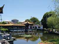 Spacious park with seasonal flowers and a peaceful pond,