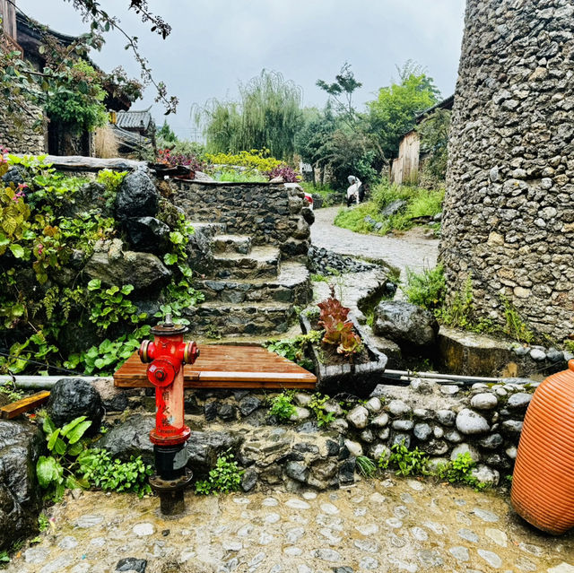 Quaint stone village under Yulong Mountains