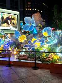 PURPLE FLOWERS AND GLOWING LIGHTS IN SHUNCHENG SHOPPING MALL