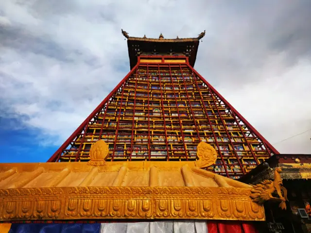 Tibet | A massive cliff face, a masterpiece of Buddha statues by generations of Tibetan sculptors