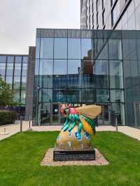 Civic Symbols in Stone and Swarm – A Reflection Outside Manchester Museum