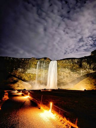 A glowing waterfall at night: Seljalandsfoss