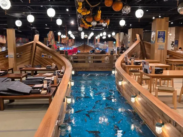 Tian Tong Pavilion Restaurant - Featuring three massive boat-shaped seating areas and a fish pond with swimming fish.