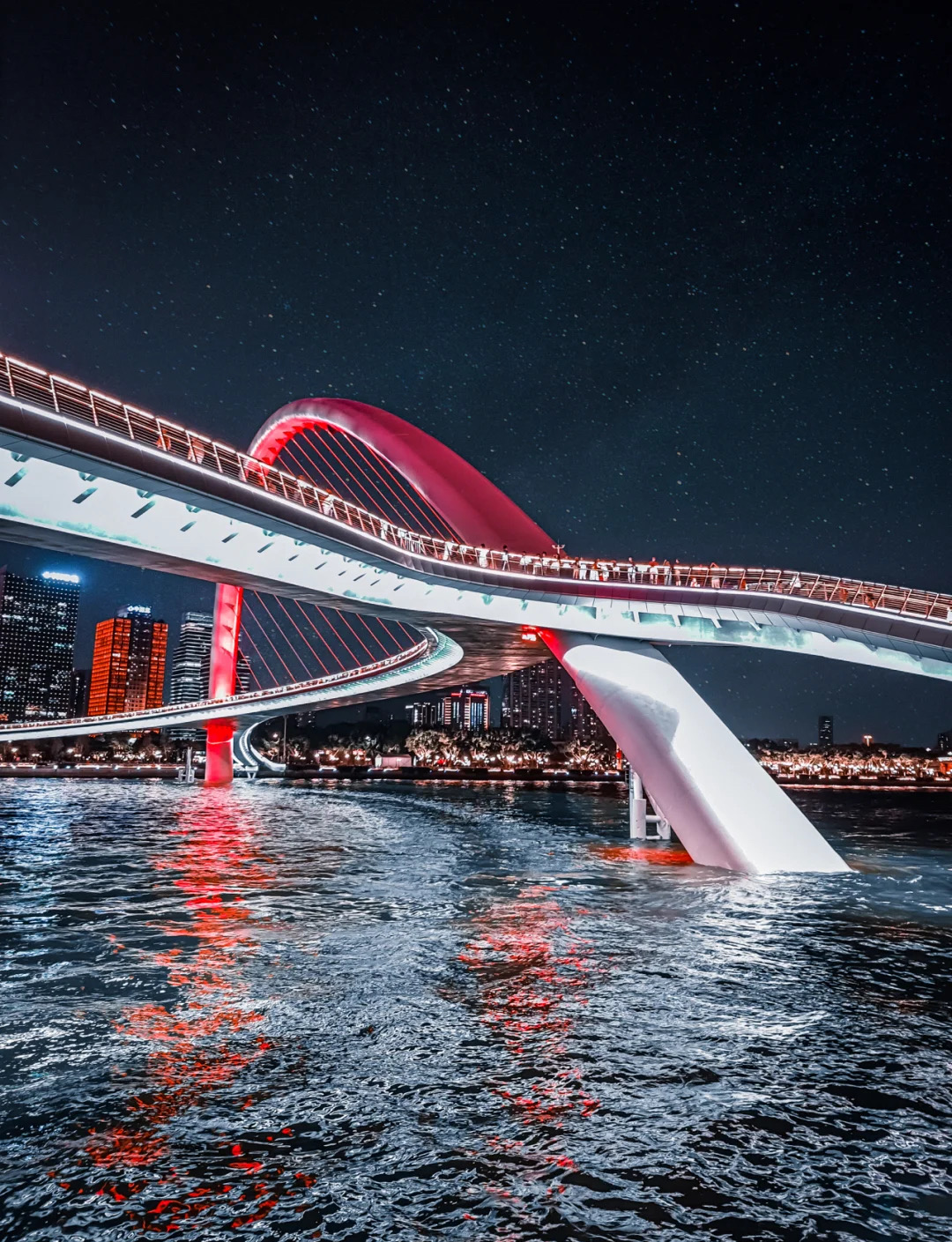 Haixin Bridge|The "Moonlight Box" on the Pearl River, breathtaking night views!🌉

· --

🌟 Must-Visit Reasons
· **The world's largest span** curved beam and inclined arch pedestrian bridge, combining beauty and technology
· **360° unobstructed viewing platform**: panoramic views of Canton Tower, Zhujiang New Town, and Pazhou Exhibition Center
· **Free admission**! Walk directly, romantic vibes peak after dusk lighting

· --

📸 Top Photo Spots
1. **Under the bridge arch looking up** (wide-angle lens): silver ribs like a phoenix spreading wings, futuristic explosion
2. **Bridge walkway**: with Canton Tower as the backdrop, capture the cinematic feeling of "walking under the starry sky"
3. **Ersha Island side stairs**: capture the flowing curves of the bridge alongside Pearl River cruise boats in one frame

· --

🌆 Golden Time Schedule
· **17:30-18:30**: Sunset blue hour, sky gradually turns purple-pink
· **19:00-20:00**: All lights on, the bridge looks like glowing silk ribbons
· **Every Tuesday, Thursday, Saturday**: During Canton Tower light shows, buildings on both sides light up in sync

· --

🧭 Cultural Symbolism Explained
▫️ **"Lingnan Guqin" imagery**: bridge arch design inspired by the famous Cantonese musical instrument, night lights flow like strings  
▫️ **"Water Flower Market" gene**: wave pattern on the bridge deck symbolizes the Pearl River’s millennium shipping culture  
▫️ **Dialogue between old and new central axes**: north connects to traditional axis "Tianhe Floating Silk," south faces modern axis "Little Waist"

· --

🚶 Easy Route Plan
```mermaid
graph LR
A[APM Haixinsha Station] --> B(Haixinsha Asian Games Park)
B --> C{Bridge Entrance}
C --> D[Northern Bank Huacheng Square]
C --> E[Southern Bank Canton Tower]
E --> F[Tram Experience]
```

· --

💡 Hidden Activities
✅ **Morning exercise and sunrise viewing**: climb the bridge before 6:30 to see the city wake up in the dawn glow  
✅ **Collect commemorative stamps**: special bridge postmark available at the service kiosk (weekends only)  
✅ **Drone perspective**: panoramic shots of the "Pearl River jade belt wrapping the Little Waist" allowed with prior approval

· --

🍜 Nearby Food Options
· **North bank**: Huachenghui underground plaza (Cantonese dim sum / trendy cafes)  
· **South bank**: "Pearl River Water Tour" themed restaurant under Canton Tower (around $150 per person with river view)  
· **Hidden gem**: "Riverside BBQ Bar" night snacks near Ersha Island Sports Park

· --

⚠️ Notes
▫️ Advance reservation required via the "Haixin Bridge" official WeChat account (2 days ahead recommended on weekends)  
▫️ No cycling/skateboarding allowed; bridge traffic may be controlled in sections during peak times  
▫️ May close temporarily during heavy rain or strong winds

· --

📌 Tips
> "Wednesdays have the fewest people at night! Best for empty shots  
> Bring a bottle of bubble solution, blowing bubbles under the lights doubles the dreaminess✨  
> Bridge LED color temperature changes with festivals (Chinese red for Spring Festival / moonlight white for Mid-Autumn Festival)"

· --

📍 Location: Haixin Bridge (5-minute walk from APM Line Haixinsha Station Exit A)  
⏰ Hours: 7:00 AM - 11:00 PM (last entry at 10:40 PM)
