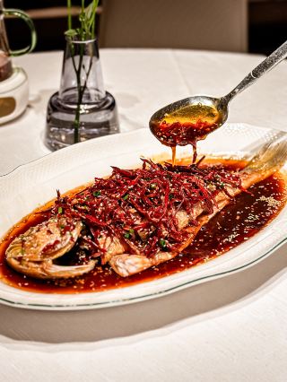 A stunning view of Victoria Harbour at night paired with exquisite Hunan cuisine! Experience a Michelin-level meal for two at Xiang Shang Xiang for $899.