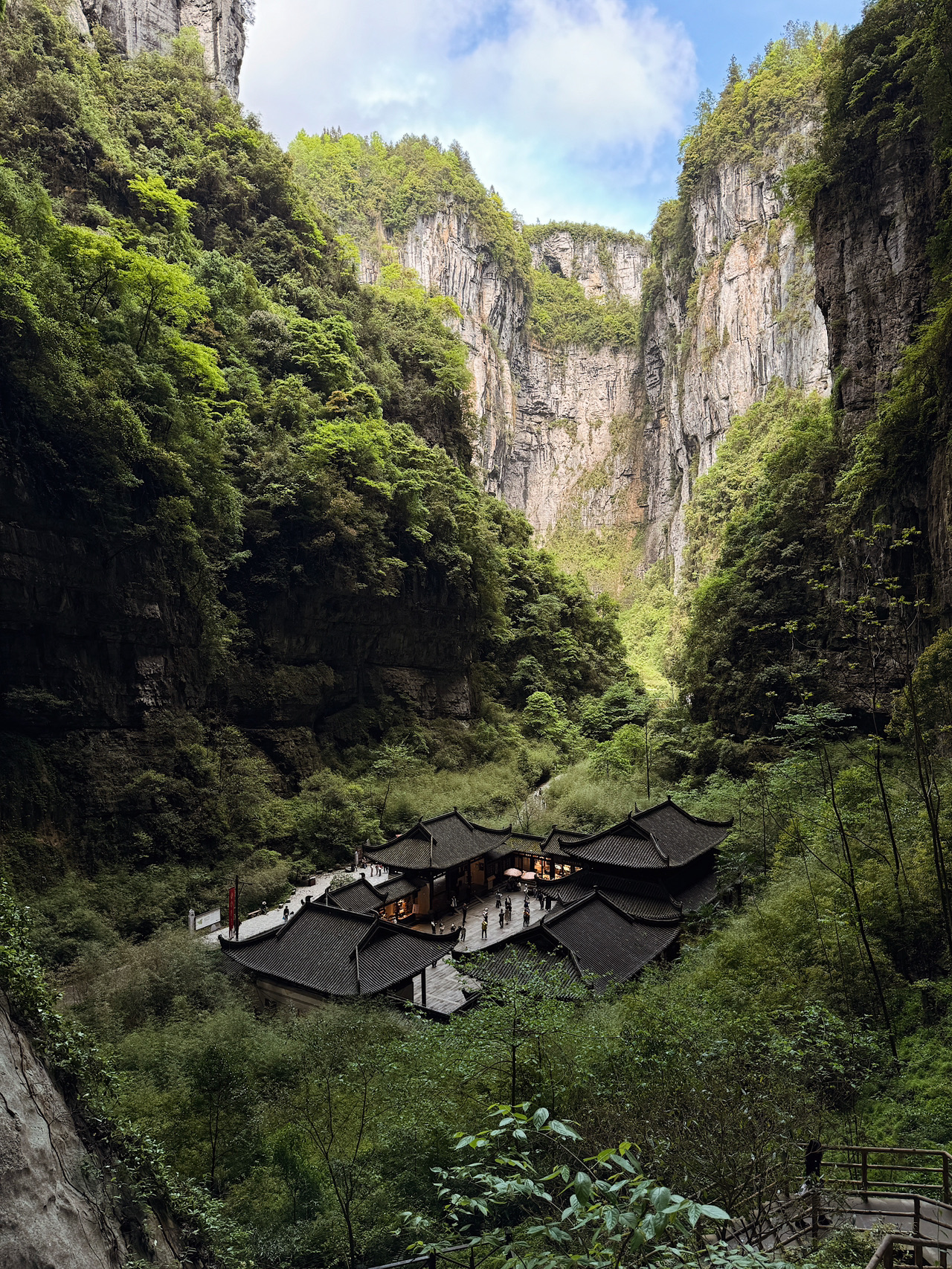 When you look at The Three Natural Bridges in the Wulong district, your brain can't even process the scale at first.

Three giant natural stone arches. Sheer cliffs. Mist. Narrow trails down below and the distinct feeling that you're stuck inside some CGI.

But the coolest part is that this place was actually used as a movie set.

This is the exact filming location for the movie
Transformers: Age of Extinction

Remember that scene surrounded by massive cliffs? That's Wulong.

The area looks so surreal, you'd think it was a custom-built movie set. But nope—nature just got bored and decided to create something absolutely insane.

By the way, there's another cool detail here—right underneath one of the arches sits an ancient Chinese house that looks incredibly tiny against the backdrop of these massive rocks. That's where the true scale of this place really hits you.

Honestly, it's one of those spots in China that completely shatters your typical expectations of the country—no skyscrapers, just wild nature and the feeling of stepping into a whole other world.