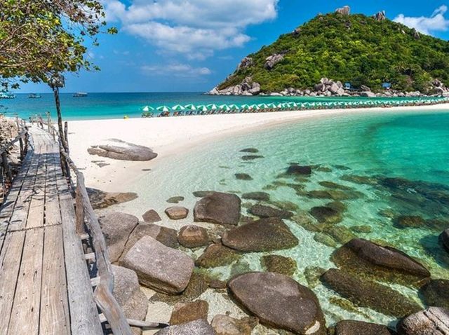 stunning beaches, crystal-clear waters, and lush palm-covered hills