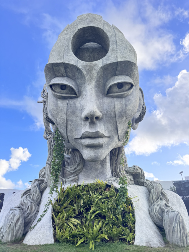 Nuanu Park in Bali is a large-scale project by Russian entrepreneur Sergey Solonin, combining nature, technology, and art. Located in the Tabanan district along the coast, it spans an area of 44 hectares.

Things to do:

1. Take a stroll along scenic routes
- Magical Garden with tropical plants, orchids, and butterflies.
- Eco-trail stretching 5 km with shaded alleys and cool resting spots.

2. Visit the spa and relax
- Bali's largest SPA & Wellness center for relaxation and rejuvenation.
- Retreat center and Oshom hotel for a complete rest experience.

3. Watch shows and movies
- The Dome Experience: an immersive dome with a 360° panoramic screen (600 m²). Multimedia performances like "Bhuvana Agung: Bali Mysticism in Life" are showcased here.
- Aurora Media Park: a zone with interactive installations where illuminated palm trees and banyans respond to visitors' movements, emitting sounds and fragrances.

4. Grab a bite at cafes and restaurants
- Luna Beach Club: restaurants, a water bar, a wine cellar, and a gelato bar.
- Neo-food Court: 17 outlets offering global cuisine.

5. Interact with animals
- Pacha Alpaca Park: an opportunity to pet and feed alpacas.
- Butterfly Garden and exotic plant nursery.

6. Appreciate architecture
- 14-meter Earth Sentinels sculptures by artist Daniel Popper (illuminated at night).
- Tri Hita Karana Tower: a 30-meter interactive tower projecting dynamic visuals during evening shows.
- Buildings in traditional Balinese style using natural materials.

7. Experience evening AI shows
- Artificial intelligence "Aurora" manages the park's media systems.
- Interactive performances with audiovisual effects take place at Aurora Media Park.
- Light shows are organized at Luna Beach Club and Tri Hita Karana Tower (starting at 6:30 PM).

8. Watch the sunset at the beach club
- Luna Beach Club is located at Pantai Nyanyi beach with black sand.
- Two pools, five restaurants, panoramic relaxation areas.
- Perfect spot to enjoy the sunset.

Park highlights:
- Eco-friendly transport: electric buses operate within the park (personal vehicles are prohibited).
- Project philosophy: blending Balinese traditions (Tri Hita Karana concept—harmony with nature, people, and the divine) with modern technology.
- Development: plans to open an international school and university.

Location and logistics:
- 10 minutes from Tanah Lot Temple.
- 15 minutes from Canggu area.
- It is recommended to check the event schedule on the park's official website or social media in advance.