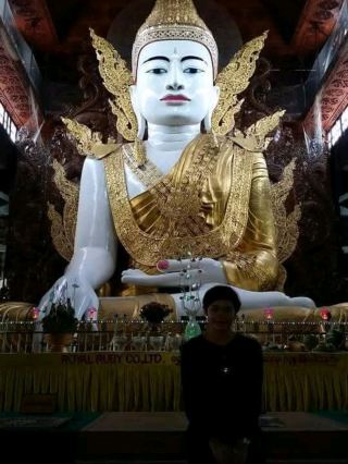 Paying respects to the white Buddha statue at Nga Htat Gyi Pagod.
