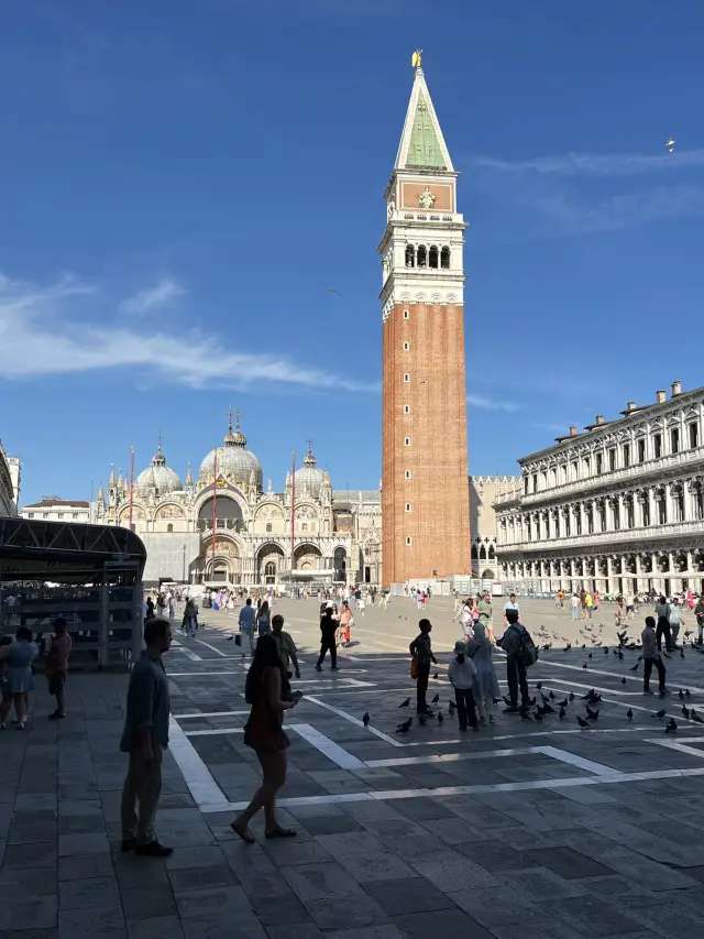 Venice's Highest Point: A Panoramic View of the Blue Canals and Red Rooftops