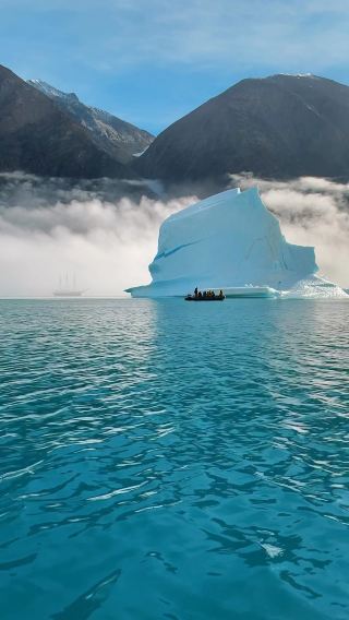 Step into the Enchanting World of Greenland: Witness the Mystical Beauty of Icebergs Surrounded by a Magical Fog!