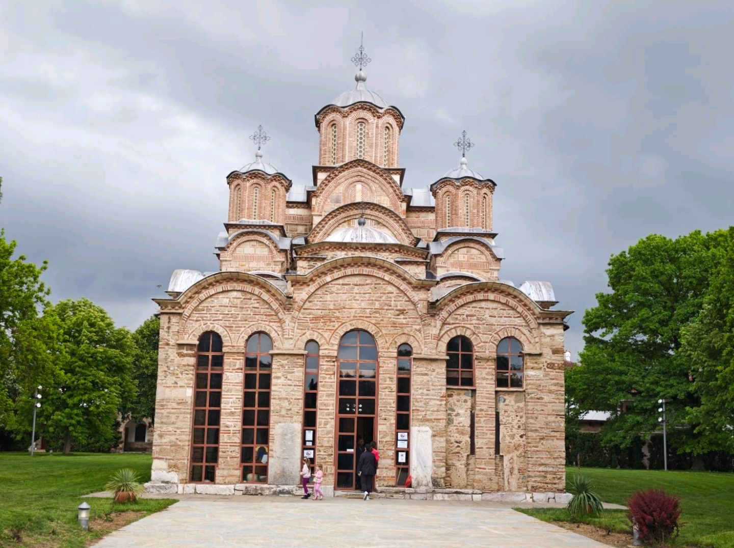 The Gračanica Monastery, located near Pristina, the capital of Kosovo, is an outstanding example of Serbian medieval religious architecture and art. As a spiritual center of the Serbian Orthodox Church, this monastery was inscribed on the UNESCO World Heritage List in 2006 as part of the "Medieval Monuments in Kosovo" for its unique and exquisite fresco art.

The monastery was founded in 1321 by Serbian King Milutin on the site of an early Christian church from the 6th century. Its architecture features the typical Byzantine "five-dome" structure, with the main church forming a cross-shaped layout. The central towering dome is surrounded by four smaller domes, a design that not only enhances the solemnity of the building but also symbolizes the connection between heaven and earth. The alternating use of red bricks and stones gives the monastery's exterior a rich texture and vibrant color, making it stand out in its surroundings.

The most captivating aspect of the Gračanica Monastery is its well-preserved interior frescoes, completed in the early 14th century. These frescoes are considered masterpieces of the Palaeologan Renaissance art style. The themes of the frescoes are diverse, including religious stories such as "The Assumption of the Virgin," "The Crucifixion of Jesus," and "The Last Judgment," as well as historical scenes depicting the life of King Milutin and other royal family members. Despite centuries of weathering and wars, the Gračanica Monastery has stood resiliently, bearing witness to the complex history of the Kosovo region. It continues to serve as a center of faith for Serbian Orthodox Christians, attracting countless pilgrims and art enthusiasts every year. The monastery is not only a tangible cultural heritage but also a spiritual symbol, connecting the past and present, faith and art.