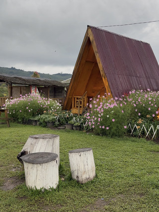 A cafe in Berastagi with a flower garden and mountain view