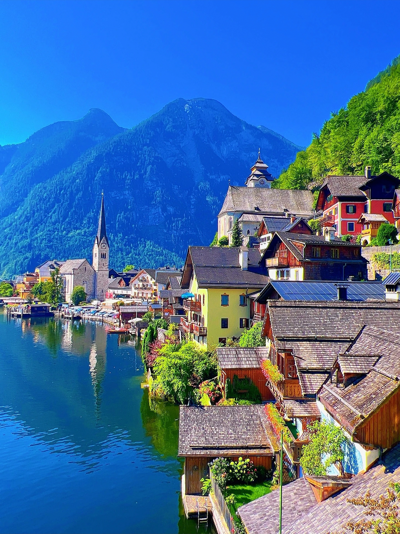 This is **Hallstatt, Austria**, known as the world's most beautiful lakeside fairytale town, bordering Hallsch