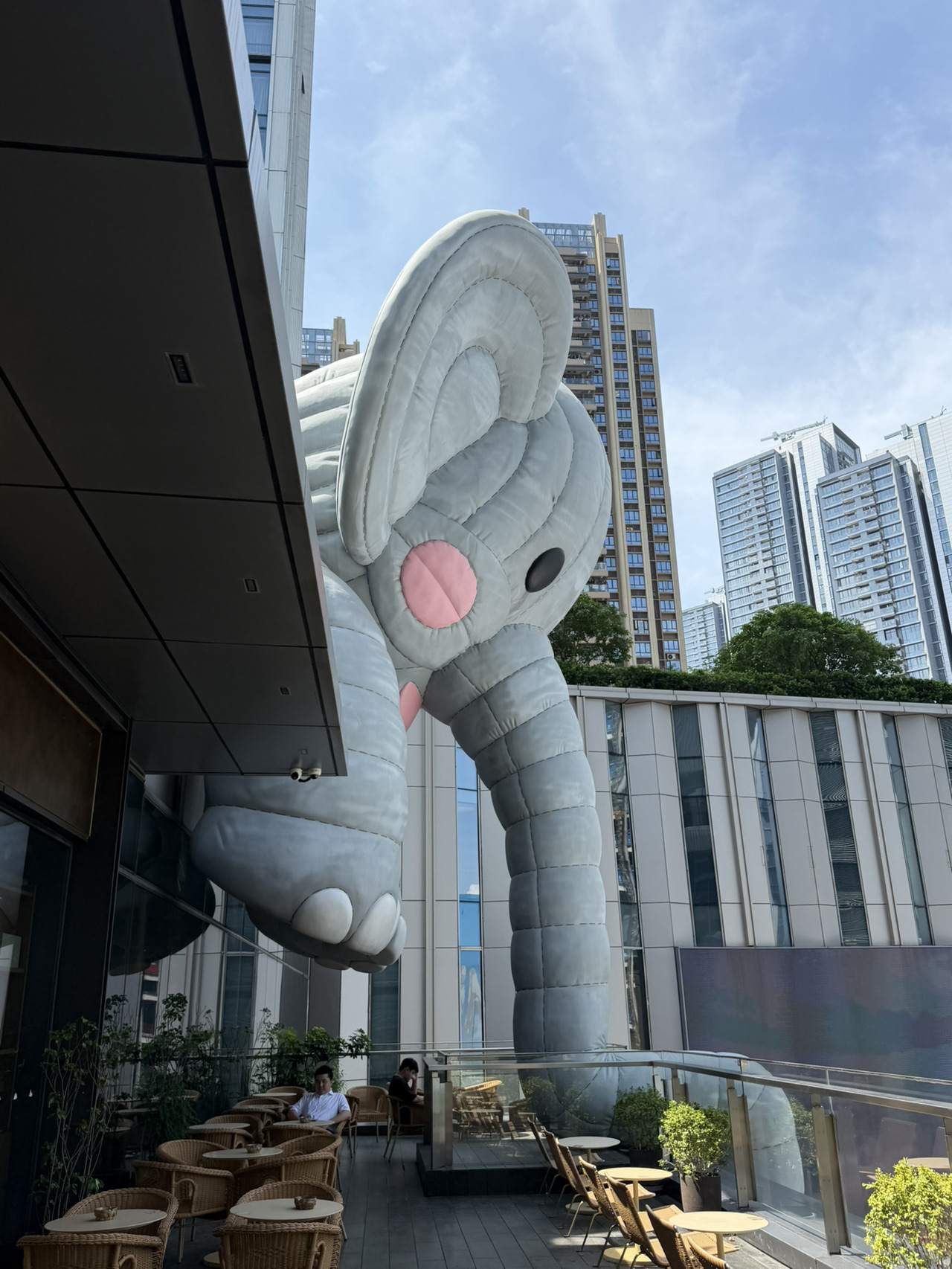 Hidden inside Shenzhen’s trendy MixC World is one of the city’s most surreal attractions: a colossal sleeping human sculpture so realistic that many visitors do a double take. Created by Korean eyewear brand  Gentle Monster⁠￼, HAUS NOWHERE Shenzhen blurs the line between art installation, sci-fi exhibition, and retail space. Since opening in September 2024, it has become one of Shenzhen’s most photographed attractions.  

✨What Makes It Special? ✨

The star attraction is the Colossal First Human, a giant seated figure with astonishingly lifelike skin textures, veins, hair, and facial details. The sculpture forms part of the fictional “Insect Kingdom” narrative, a story about giants, insects, and animals that have coexisted for 10,000 years. As you explore the three floors, you’ll encounter giant mantises, enormous bison sculptures, mysterious oracle heads, and immersive artwork that feels straight out of a science-fiction movie.  

📸Best Photo Spots

· The giant human sculpture at the entrance
· The grand staircase overlooking the main hall
· The Three Oracles installation on the upper floors
· The giant insect-themed artworks and murals
· Wide-angle shots from the upper levels looking down at the giant figure

The best photos are usually taken shortly after opening on weekdays, before the crowds arrive. Visitors often queue simply to capture photos with the giant sculpture.  

🏬More Than Just a Store

HAUS NOWHERE isn’t designed as a typical shopping mall tenant. Instead, it follows a “Future Retail” concept where art and storytelling take center stage. Even if you have no intention of buying anything, the immersive installations alone make it worth visiting. Many visitors spend more time exploring and taking photos than shopping.  

Visitor Information

📍 Location: Water Plaza, MixC World, Nanshan District, Shenzhen

HAUS NOWHERE Shenzhen

Admission is free, and the attraction is easily reached via Shenzhen Metro. Allow 30–60 minutes to explore the space, though photography enthusiasts may want considerably longer.  

Why You Should Visit

If you’re looking for something uniquely Shenzhen, HAUS NOWHERE delivers. It’s part art gallery, part futuristic dreamscape, and part social-media phenomenon. Whether you’re a fan of architecture, photography, or simply unusual attractions, standing beneath the giant sleeping human is an experience you won’t forget.  