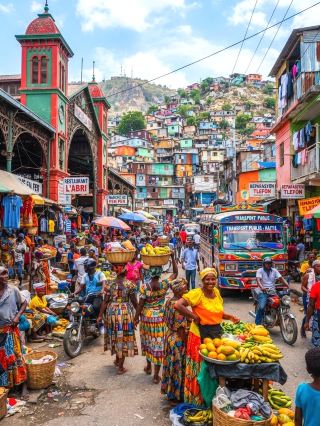 Port-au-Prince is a tourist destination brimming with art and exoticism, blending the passion of the Caribbean, the vibrancy of African culture, and the traditions of French colonialism. Walking through the city center, you'll find a vibrant musical atmosphere everywhere, with realistic yet colorful street murals brimming with creativity. As the capital of Haiti, Port-au-Prince is the perfect starting point for understanding Haitian culture.

Recommended Itinerary: It's suggested to start from downtown Port-au-Prince, exploring art districts (such as Pétion-Ville) to admire authentic murals, handicraft shops, and experience Haiti's unique creative culture. Afterwards, you can visit the Musee du Pantheon National Haitien (Haitian National Pantheon Museum) to learn about Haitian history, the independence movement, and the story of the famous leader Jean-Jacques Dessalines. The museum's exhibits are detailed, offering a true understanding of the Haitian spirit. For lunch, try the authentic Creole restaurant, where Haitian cuisine has a touch of French and Caribbean influence, such as stewed chicken and grilled fish with beans and rice.

Must-Do Activities:

1. Visit a local market, such as the Marché de Fer (Iron Market), to soak up the lively atmosphere and buy handicrafts or specialty spices.

2. Jump into a live street music concert; Port-au-Prince often features impromptu band performances that are sure to excite you.

3. Take a short trip to a tropical beach, such as a short drive to nearby Carrefour or Côte des Arcadins, to enjoy the clear waters and white sand.

Photo Spots:
· Huge murals and colorful facades of cocktail bars in the Pétion-Ville art district
· The unique French cast-iron structure of the Marché de Fer (Iron Market)

Exterior view of the Haitian National Pantheon Museum

Sunset views, especially at Côte des Arcadins

Tips and Precautions:

1. Be mindful of your belongings when walking on the streets and avoid carrying valuables.

2. Ask beforehand if you are allowed to take photos at certain locations, and respect the wishes of local residents.

3. It is recommended to visit the main attractions during the day; choose safe transportation when traveling at night. 4. Try to communicate with the locals. Haitians are warm and hospitable, and English and French are widely spoken.

Port-au-Prince's rich culture and history make every step a new experience. Whether you love art, music, or are passionate about exploring local cuisine, it's worth exploring in depth!

Topics: #Port-au-PrinceArtExperience #HaitialCulture #CaribbeanMusic #MarketExploration #MuralViews