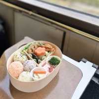🌿🚂🌸 Delight your taste buds with exquisite bento boxes aboard the Yufuin no Mori Train in Japan! 