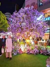 PURPLE FLOWERS AND GLOWING LIGHTS IN SHUNCHENG SHOPPING MALL