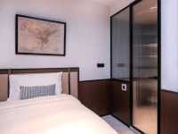 Interiors are clean, minimalist, and smart, featuring comfortable bedding, smart TVs, and en-suite
