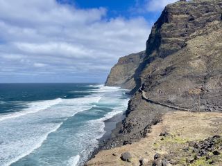 🌄 Cliffside Serenity Awaits on the Cruzinha to Ponta do Sol Trail 🌊✨  
Ready to lace up your hiking boots for a jaw-dropping coastal walk? This trail is a must for nature lovers, leading you along dramatic cliffs where waves crash below and the sunny sky stretches forever above.  

🧭 Recommended Route:  
Start in Cruzinha and follow the marked path hugging the coastline to Ponta do Sol. You’ll pass tiny villages, terraced hillsides, and endless Atlantic vistas—a feast for the eyes at every turn!  

🎒 Must-Do Experiences:  
Pause for a snack in one of the villages—the locals are ever friendly and often sell fresh fruit or cold drinks. Take your time to soak up the rugged beauty; every headland has a new perspective.  

📸 Top Photo Spots:  
Snap the coastline’s wild cliffs where the ocean explodes against the rocks. For extra “nature-vision” shots, capture the vivid blue waves framed by lush terraces; the clear sky makes each photo pop. Pro tip: Golden hour illuminates the cliffs for truly Insta-worthy images.  

📝 Practical Visiting Tips:  
The trail is year-round and open all day (address: 5VP9+3R2, Ribeira Grande). Begin early for cooler temps and emptier paths. Bring plenty of water, sunblock, and sturdy shoes—the terrain can get rocky and uneven.  

⚠️ Key Precautions:  
Watch the trail edges, which can be steep and exposed. Weather is usually sunny, but strong winds may blow—so secure hats and keep electronics safe. If hiking solo, let someone know your route beforehand.  

#SantoAntao #CapeVerde #CoastalHiking #NatureVision #OutdoorAdventure 
