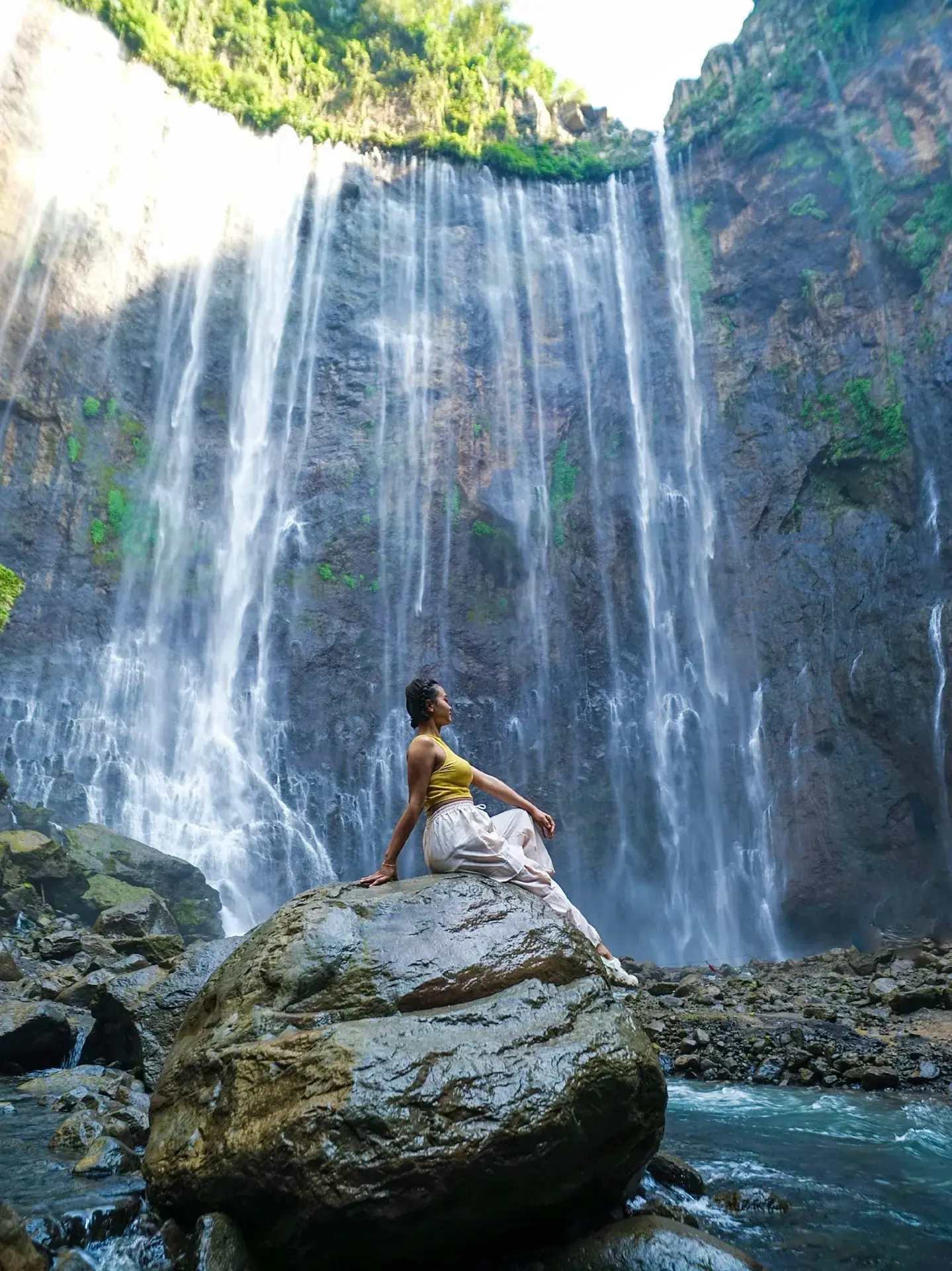 Tumpak Sewu Waterfall: Indonesia’s “Thousand Waterfalls” is pure jaw-drop territory! 🌊🌿 Hidden deep within East Java, its horseshoe curtain of water plunging over lush cliffs is guaranteed to fill your camera roll (and your soul). 

Start at the panoramic viewpoint near Pronojiwo for that classic, sweeping vista—the ultimate “insta-worthy” shot, especially just after sunrise when the mist catches the light. For the real adventure, follow the steep, slippery path down to the base. Expect bamboo ladders, slick rocks, and muddy steps (bring sturdy shoes and a sense of adventure!). Once you reach the bottom, the thundering walls of water and fine spray transport you to a tropical Jurassic Park. Don’t miss wading downstream for the magical lower perspective—where every angle feels epic.

Tips: 
Bring a waterproof bag for electronics—the spray is intense at the bottom! A change of clothes is wise. Arrive early (before 9 AM) to beat the crowds and enjoy softer light for photos. Hire a local guide at the entrance if you’re not confident descending the canyon—safety first! The trail can be challenging after rain and is not recommended for those with mobility concerns.

Precautions: 
The descent is steep and can be extremely slippery—take your time and skip it in heavy rain. Be mindful of strong currents near the pool base. Little local warungs at the entrance serve tasty snacks for post-hike rewards!

#TumpakSewu  #EastJava  #Waterfalls  #TravelTips  #NatureLovers 