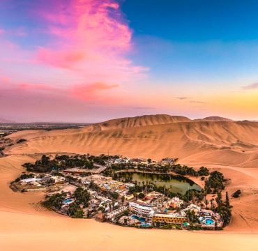 Huacachina Oasis, Peru 🇵🇪 — A Green Paradise in the Golden Desert

Imagine discovering a beautiful green lagoon surrounded by enormous golden sand dunes. Welcome to Huacachina Oasis, one of Peru’s most extraordinary landscapes, located near the city of Ica in southwestern Peru.

This small oasis looks almost unreal, with palm trees, charming buildings, and calm water nestled in the middle of an immense desert. The contrast between the lush greenery and the endless golden sands creates a spectacular scene for travel photography. During sunset, the dunes glow with warm shades of gold and orange, making the landscape even more magical.

Huacachina is also a destination for adventure lovers. Visitors can experience thrilling dune buggy rides, try sandboarding down steep sandy slopes, or simply enjoy the peaceful views around the lagoon. For the best experience, plan your visit for the late afternoon and bring sunscreen, water, and comfortable clothing.

If you are exploring Peru, consider combining Huacachina with a visit to Ica and the nearby Paracas region.

📍 Location: Huacachina, Ica Region, Peru

#HuacachinaOasis  #PeruTravel  #DesertLandscape  #SandDunes  #SouthAmerica  #AdventureTravel  #TravelPhotography  #Tripcom #travel2026 #travel #naturalwonders 