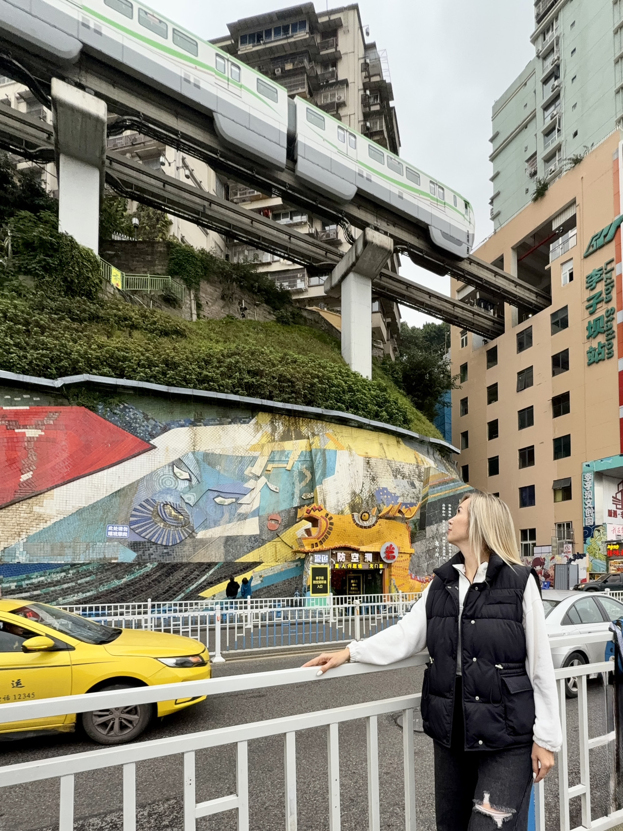 That unique apartment building where a subway car passes right through.

To film a first-person video from inside the car, you need to board the very first one, at least three stops from the exit.

There are a lot of people standing below. But it's possible to get in line for a photo. The subway passes every 7-8 minutes.