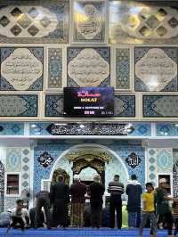 The mosque features intricate Islamic calligraphy 