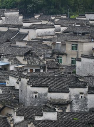 Huangshan: Overlooking Xidi Village. Layered Hui-style architecture, walking through an ink wash painting