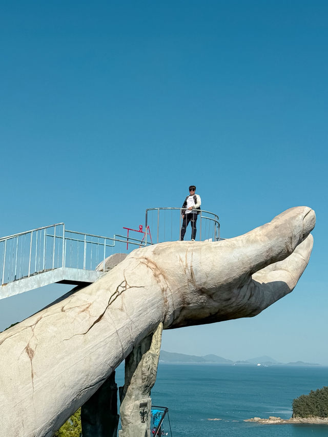 A Massive Golden Sculpture of a Human Hand Rising