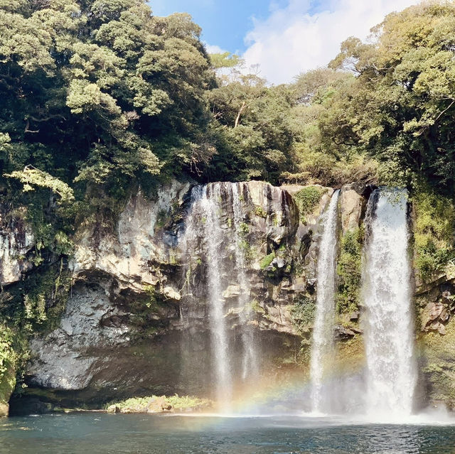 "Cheonjiyeon Waterfall: A Stunning View with a Rainbow on Jeju Island"