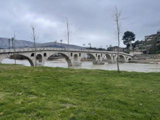 Step into the magical cityscape of Berat, Albania—where ancient stone streets, Ottoman bridges, and the legendary “thousand windows” panorama create a living postcard! 🏰🌉🏠

Start your day at Berat Castle (PX42+4Q2), towering above the city. Wander its winding paths, explore little churches and hidden courtyards, and soak up sweeping views over the river and valley. Must-do: Climb to the castle ramparts for that iconic “thousand windows” shot—the layered white houses with black roofs nestled against the mountain, especially dreamy on a cloudy day after rain! Next, head down to the Gorica Bridge, spanning the Osum River. The bridge is best photographed from the riverside with the castle and old town as a backdrop. Strolling along the riverbanks, notice the fusion of Western and Ottoman architecture—perfect for close-up building shots!

My tip: Even if the weather looks moody, bring a raincoat (umbrellas struggle in wind!). Rain makes the city’s colors pop and adds a fairy tale mist—plus, you’ll dodge crowds. For the sunny moments, golden hour brings unforgettable glows to the windows and river reflections.

Precautions: The castle’s cobblestones can be slippery in the rain; wear good shoes! Plan some snacks—cafés in the old quarter have sporadic hours. The bridge is pedestrian-friendly but watch traffic around busy times.

Don’t miss: Capturing the town from across the river, showing both banks lined with shimmering white buildings. It’s one of the most “insta-worthy” angles you’ll find!

#Berat #Albania #CulturalHeritage #ThousandWindows #TravelTips