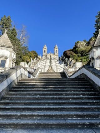 🇵🇹✨ Bom Jesus do Monte | Braga, Portugal

Another stunning place in Portugal that will make you stop and admire it! 🤍

Located in Braga, Portugal, Bom Jesus do Monte is notable for its massive stone staircase leading up to the church at the top. The view from below is breathtaking, especially the zigzag design of the stairs, with statues and architectural details to admire along the way.

What I loved most was the symmetry between the staircase and the church. On a bright blue day, the contrast with the white building and the greenery of the surrounding trees makes it look like a painting. 📸🌿

Although there are many steps to climb, there are plenty of spots to stop and take photos along the way. For those who don't want to climb all the stairs, there's also a funicular railway available.

Once at the top, you'll see both the beautiful church and a panoramic view of Braga city. The atmosphere is serene, peaceful, and charming.

This place isn't just about the view; it's also an important religious site and a UNESCO World Heritage Site.

If you're planning a trip to Portugal, this is a must-see! I highly recommend visiting Braga and seeing Bom Jesus do Monte at least once. It's another place that impressed me with both the beautiful architecture and the surrounding atmosphere. ❤️

📍 Bom Jesus do Monte, Braga, Portugal 🇵🇹

#BomJesusDoMonte #Braga #Portugal #TravelPortugal #TravelBraga #TravelEurope #InternationalTravelReview