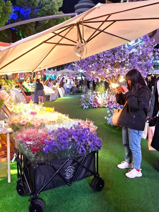 PURPLE FLOWERS AND GLOWING LIGHTS IN SHUNCHENG SHOPPING MALL